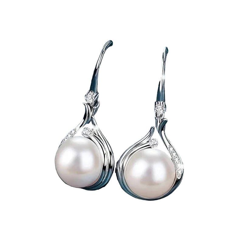 Pearl earrings with silver hooks on a dark blue fabric background