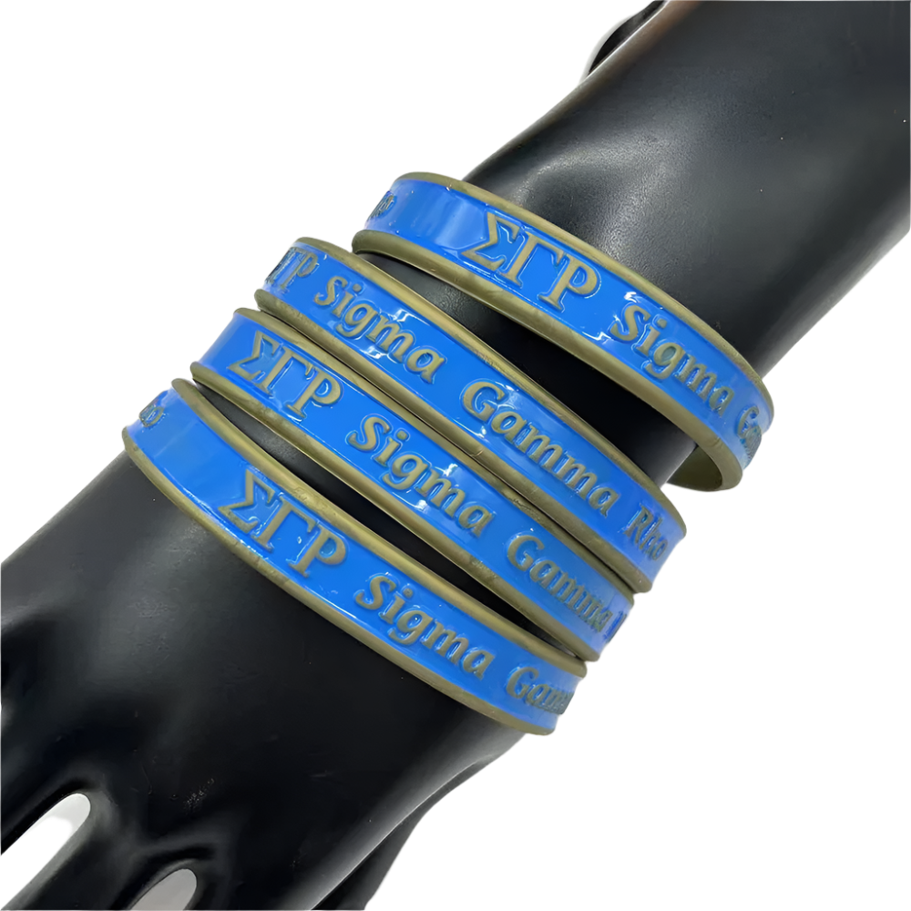 Blue and gold Sigma Gamma Rho bracelets on a black bottle against a white background