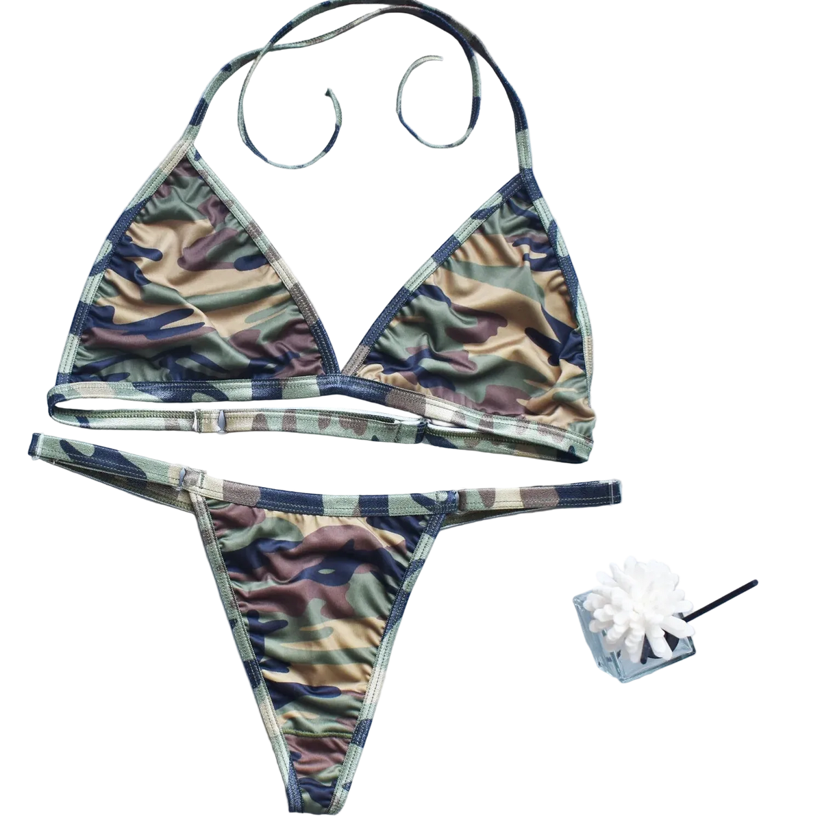 Camouflage bikini set on a light blue background with decorative elements.