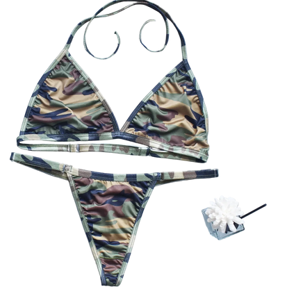Camouflage bikini set on a light blue background with decorative elements.