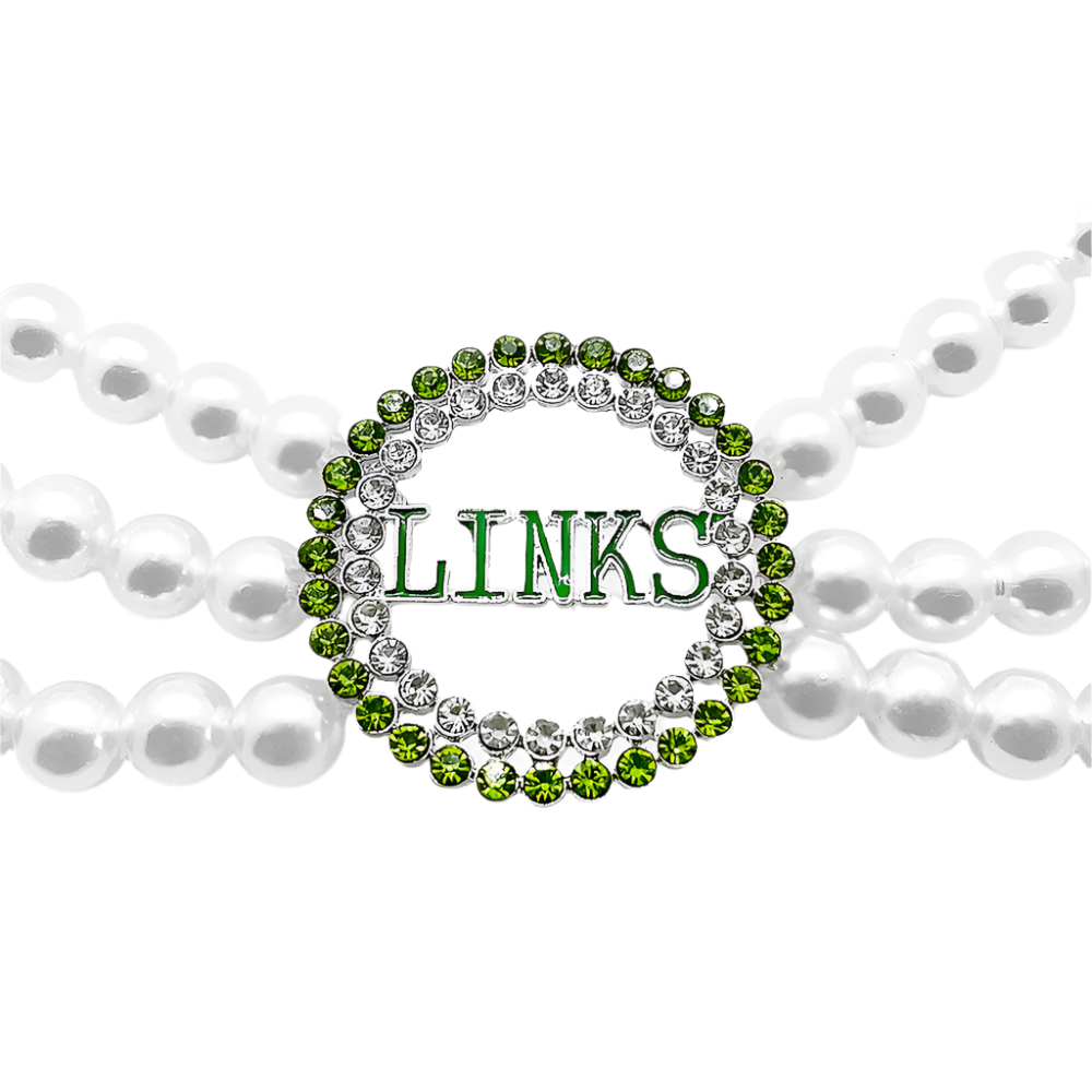 Green 'LINKS' charm on a pearl necklace with a white background