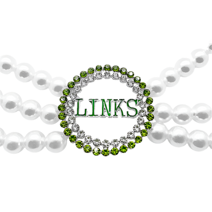 Green 'LINKS' charm on a pearl necklace with a white background