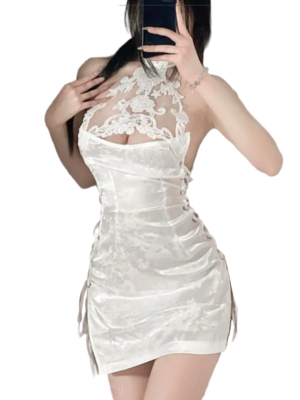 White lace dress worn by a person, with a neutral background