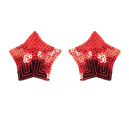 Pair of red star-shaped sequin earrings on a white background