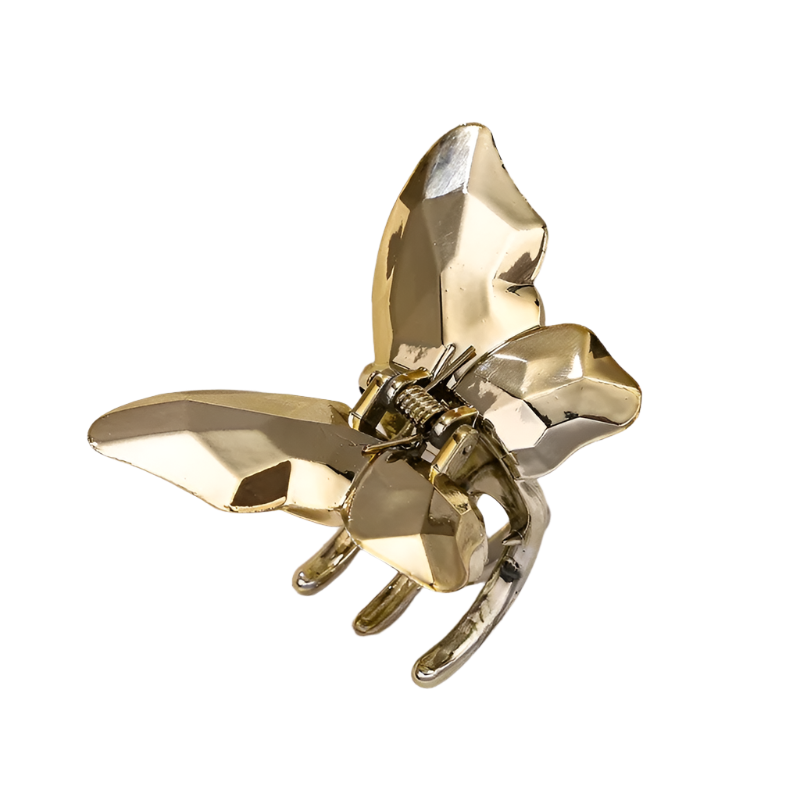 Gold bee-shaped hair clip on a white background