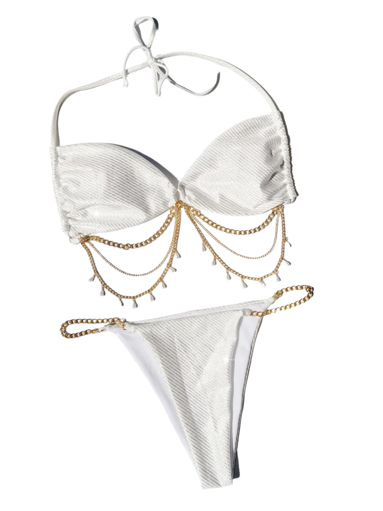 A glamorous white bikini with a metallic sheen, adorned with gold chain embellishments. The set includes a bandeau top and matching bottoms, offering a luxurious and stylish appearance.