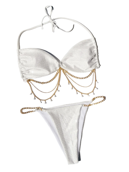 A glamorous white bikini with a metallic sheen, adorned with gold chain embellishments. The set includes a bandeau top and matching bottoms, offering a luxurious and stylish appearance.