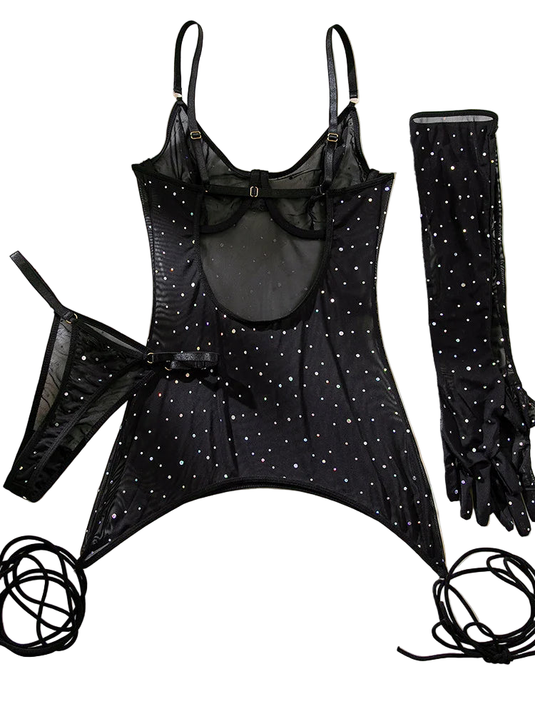 Black lingerie set with star patterns and matching gloves on a beige fabric background