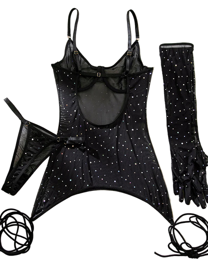 Black lingerie set with star patterns and matching gloves on a beige fabric background