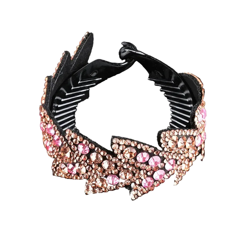 A black hair claw clip embellished with pink and rose gold rhinestones, shown on a reflective black background.