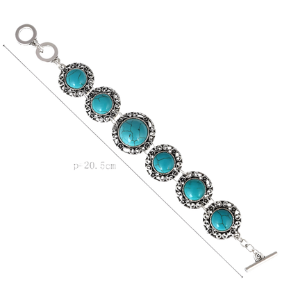 Bracelet with turquoise stones and silver accents on a white background