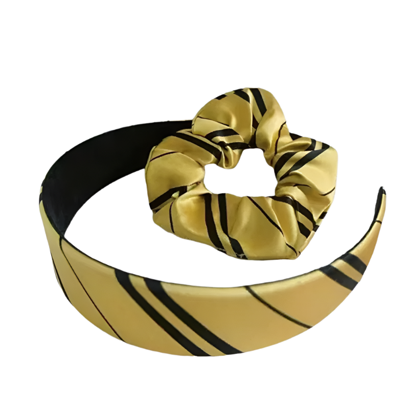 Gold headband with black stripes and matching scrunchie on a white background