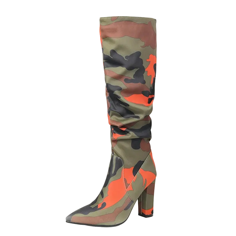 A single tall heeled boot with a pointed toe and a slouchy shaft, covered in an orange, green, and black camouflage pattern. The boot is shown on a plain white background 
