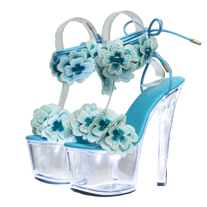 Blue high-heeled shoes with floral decorations on a white background