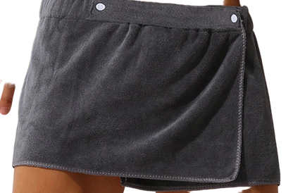 Gray towel skirt draped over a person's waist against a neutral background