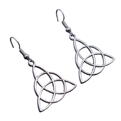 A pair of silver-toned dangle earrings with interlocking knot-like cutout shapes, shown on a dark textured surface.