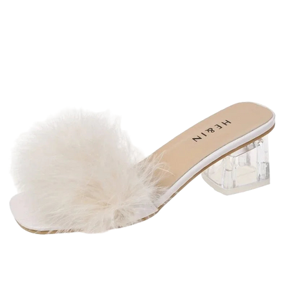White fur slide sandal with clear heel on a white background
