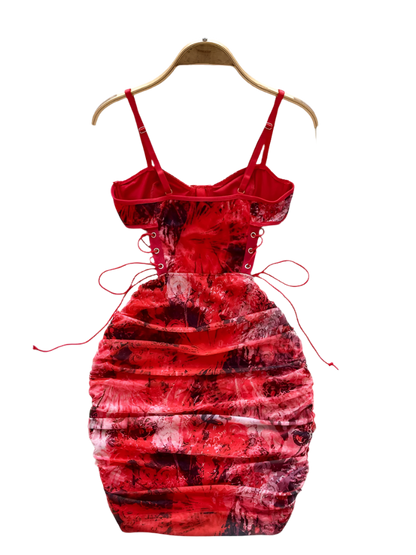 Red tie-dye dress on a hanger with a white floral background