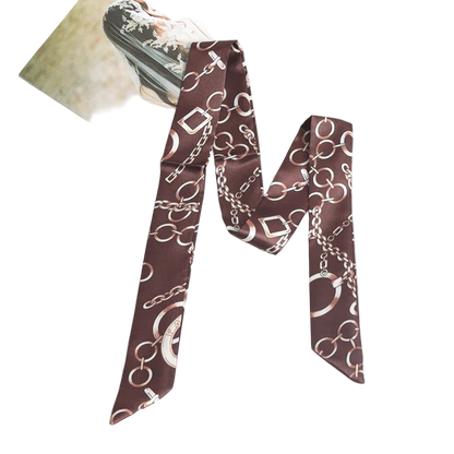 Brown scarf with chain pattern on a white surface