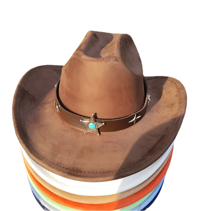 Brown cowboy hat with a star emblem on a stack of colorful hats against a grassy background