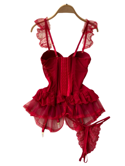 Red lace lingerie set on a hanger against a white fur background with decorative elements.