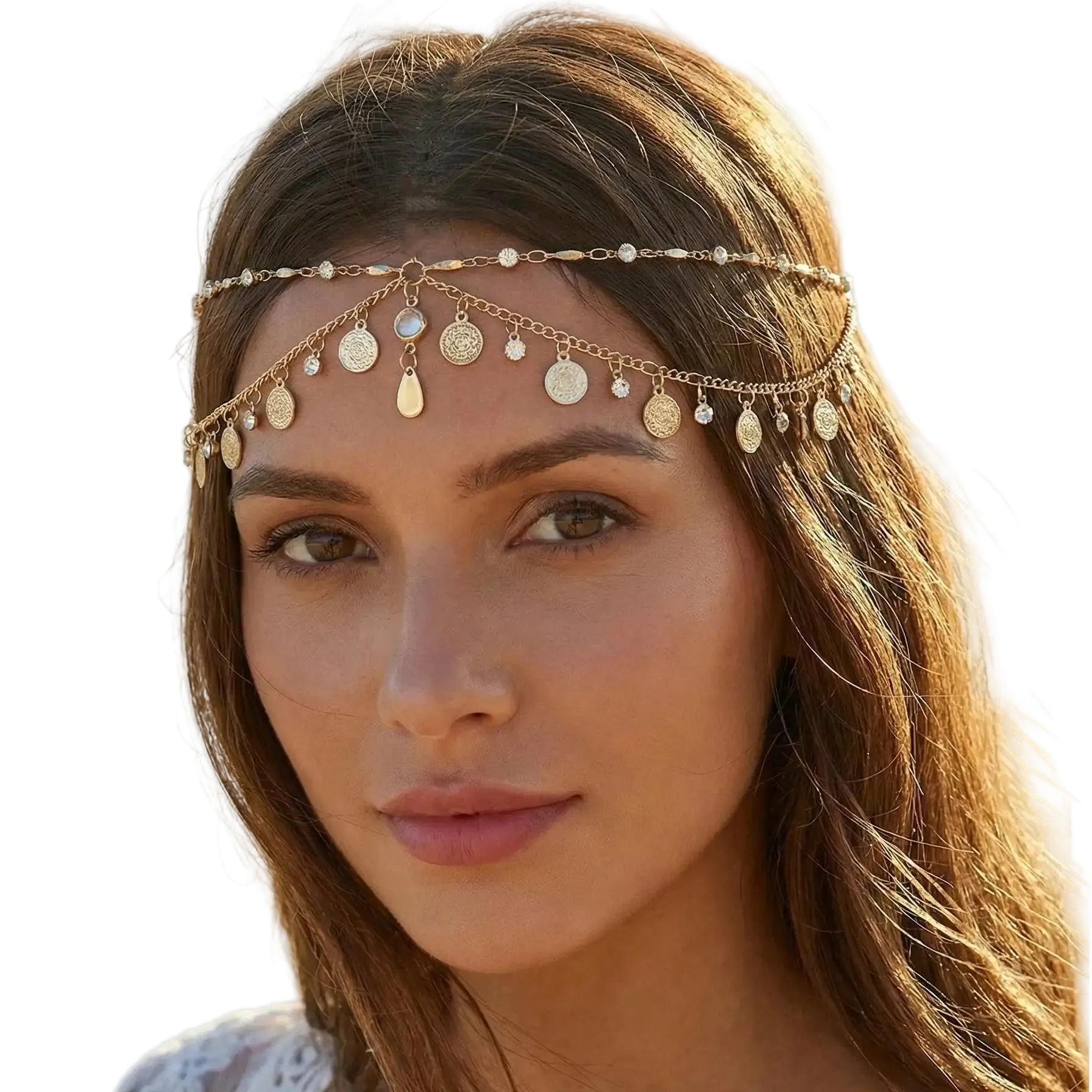 Woman wearing a gold headband with coins and beads on a beach.