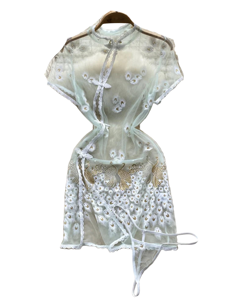 Light green embroidered top on a fur surface with floral decorations in the background