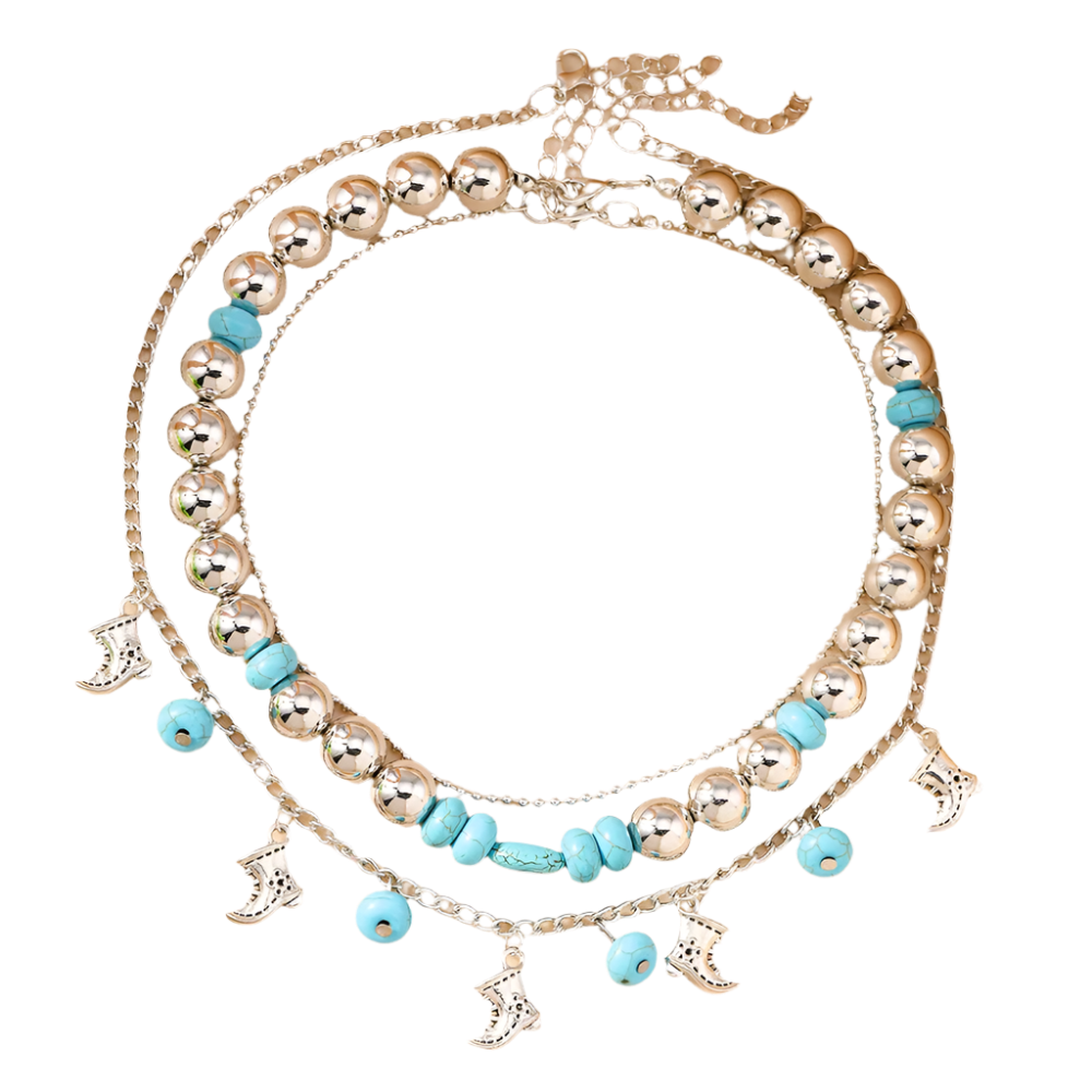 Stack of silver and turquoise beaded necklaces on a beige surface