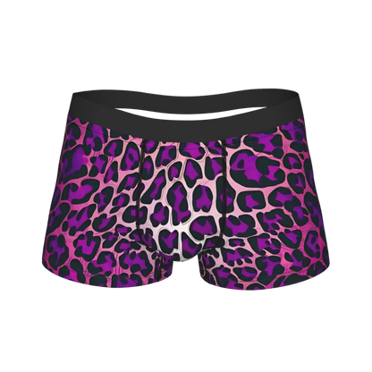 A pair of women's boxer briefs featuring a bold purple and black leopard print pattern over a light pink base, with a solid black waistband.