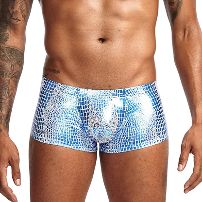 Blue patterned swim shorts worn by a person on a white background
