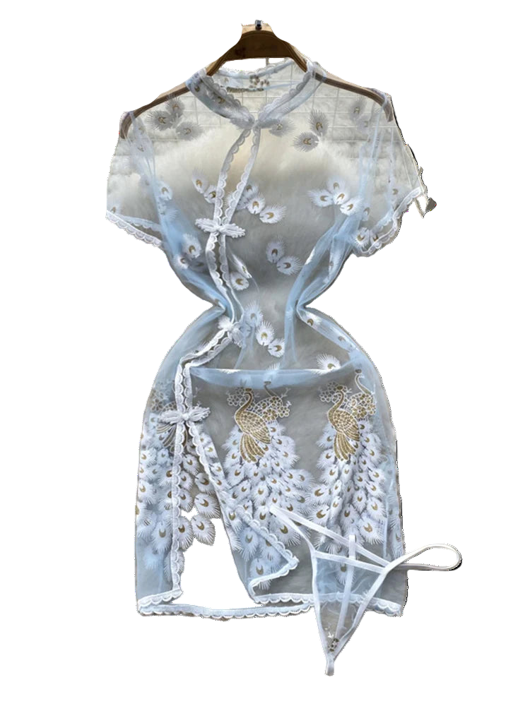 Light blue lace top with floral embroidery on a fluffy white surface