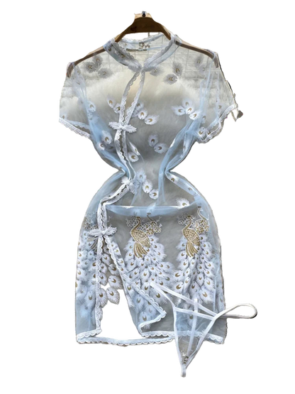 Light blue lace top with floral embroidery on a fluffy white surface