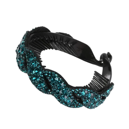 A black plastic hair comb embellished with a wavy border of sparkling teal blue rhinestones, shown on a plain white background.