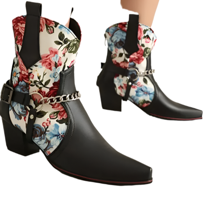 Black cowboy boots with floral patterns on a neutral background