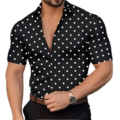 Man wearing a black short-sleeve shirt with white polka dots, blurred background
