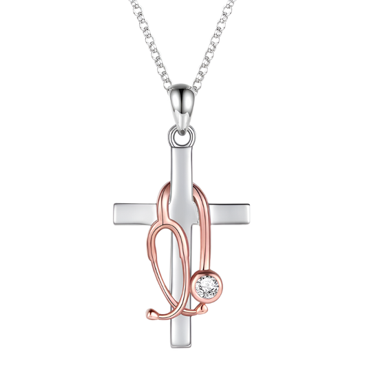 Silver and rose gold cross pendant with a chain on a white background