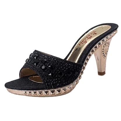 Black high-heeled shoe with studded details on a white background