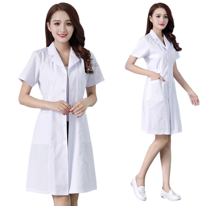 Woman wearing a white lab coat against a gray background