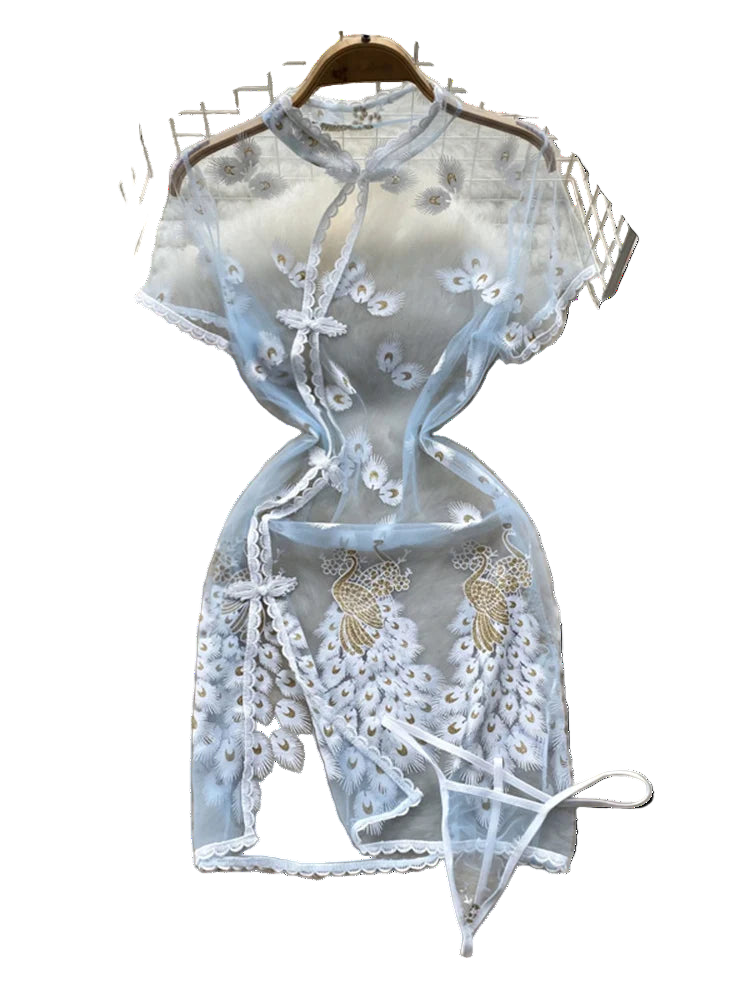 Light blue lace top with floral embroidery on a fluffy white surface