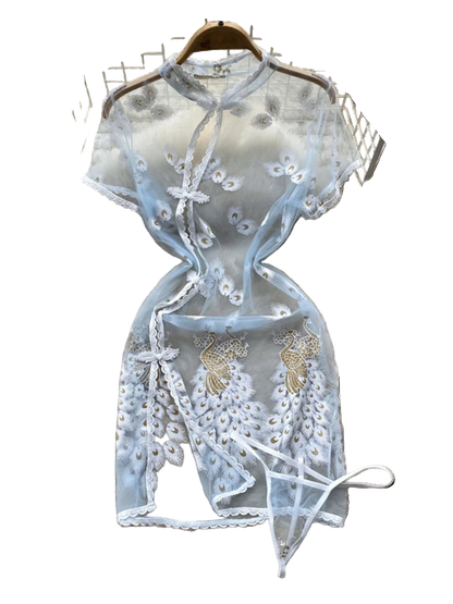 Light blue lace top with floral embroidery on a fluffy white surface