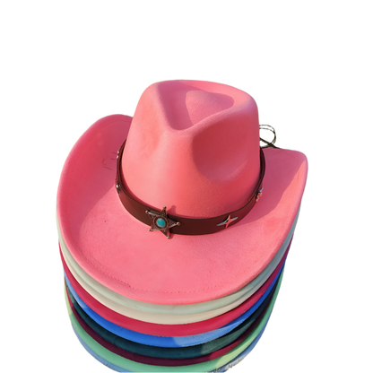 Stack of colorful cowboy hats on a grassy background