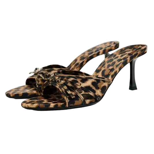 Leopard print high-heeled sandals on a light gray background