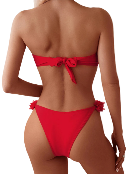 Red bikini with floral details on a plain background