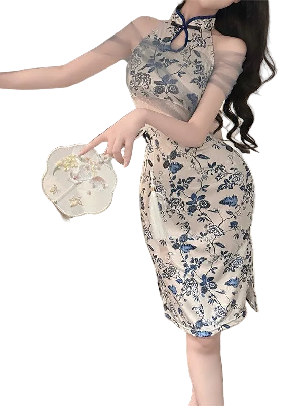 Woman wearing a floral dress in a bedroom setting