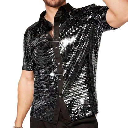 Person wearing a black sequin shirt against a neutral background