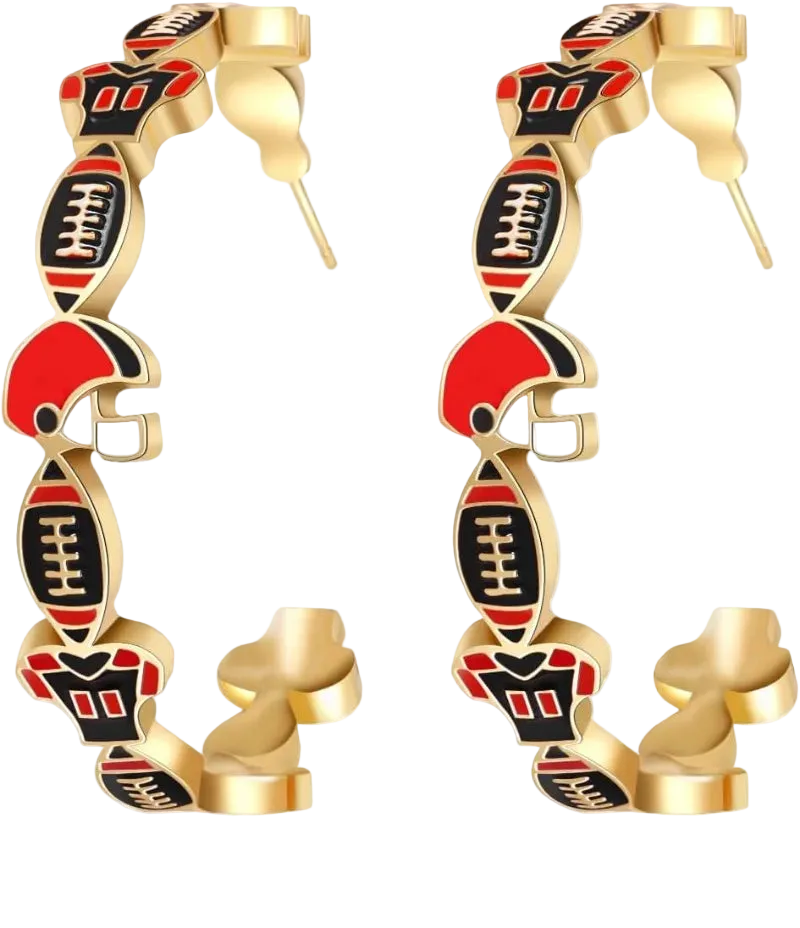 A pair of gold hoop earrings featuring dangling football and helmet charms in red, black, and gold, shown on a white background with a faint reflection.