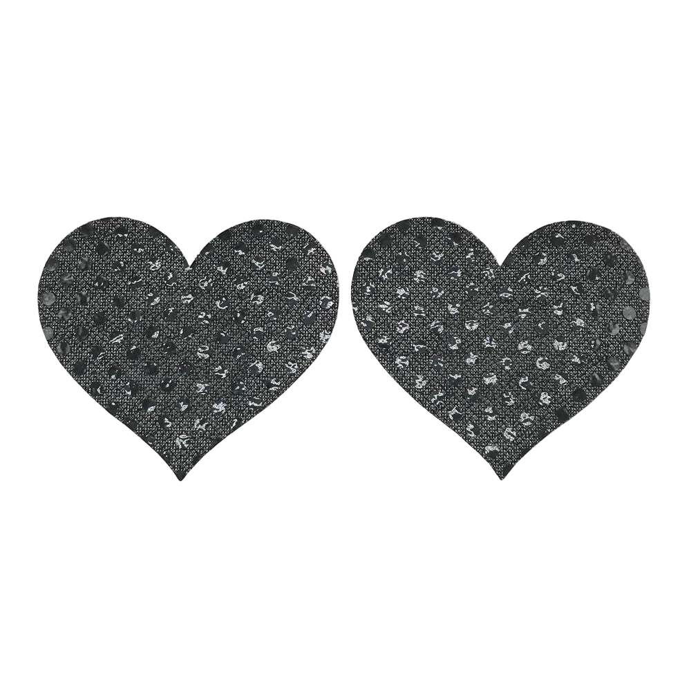 Two black heart-shaped pasties with a textured pattern on a white background