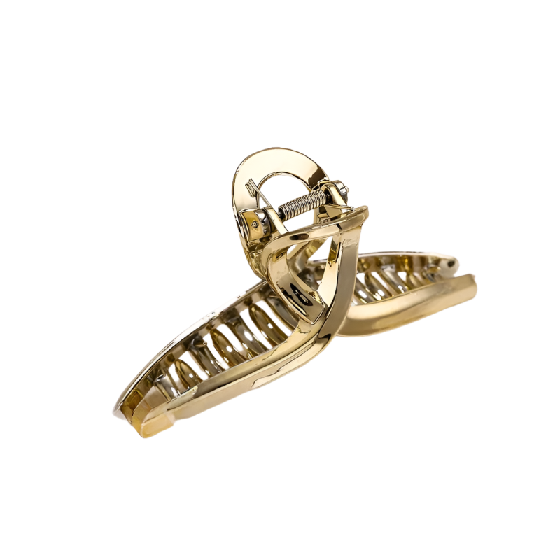 Gold hair clip on a white fabric background