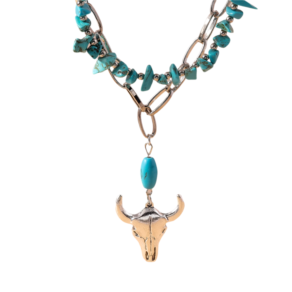 Necklace with turquoise stones and bull skull pendant on a beige background