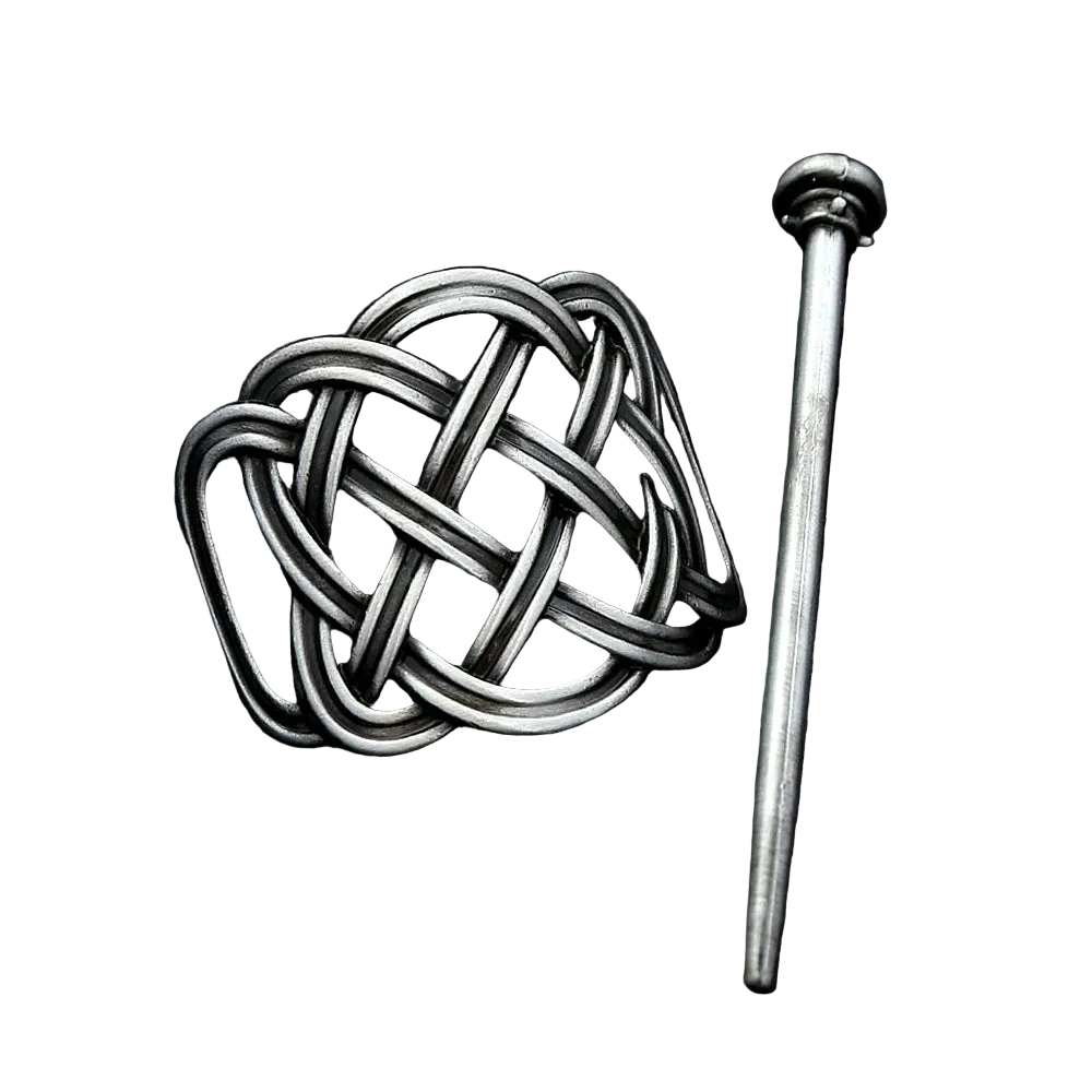 Silver knot-shaped brooch on a dark textured background